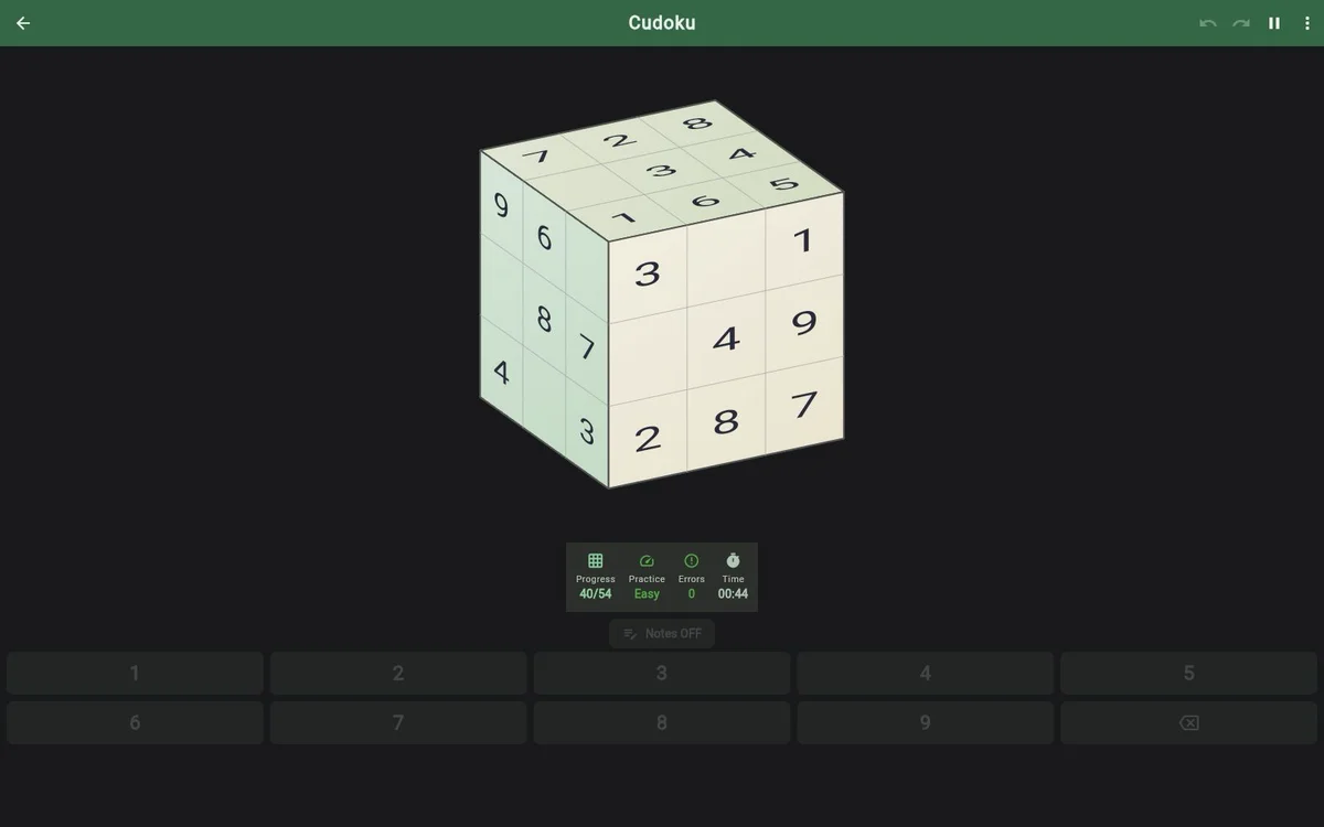 Cudoku development gameplay showing three faces of the numbered cube, progress and the number keypad.